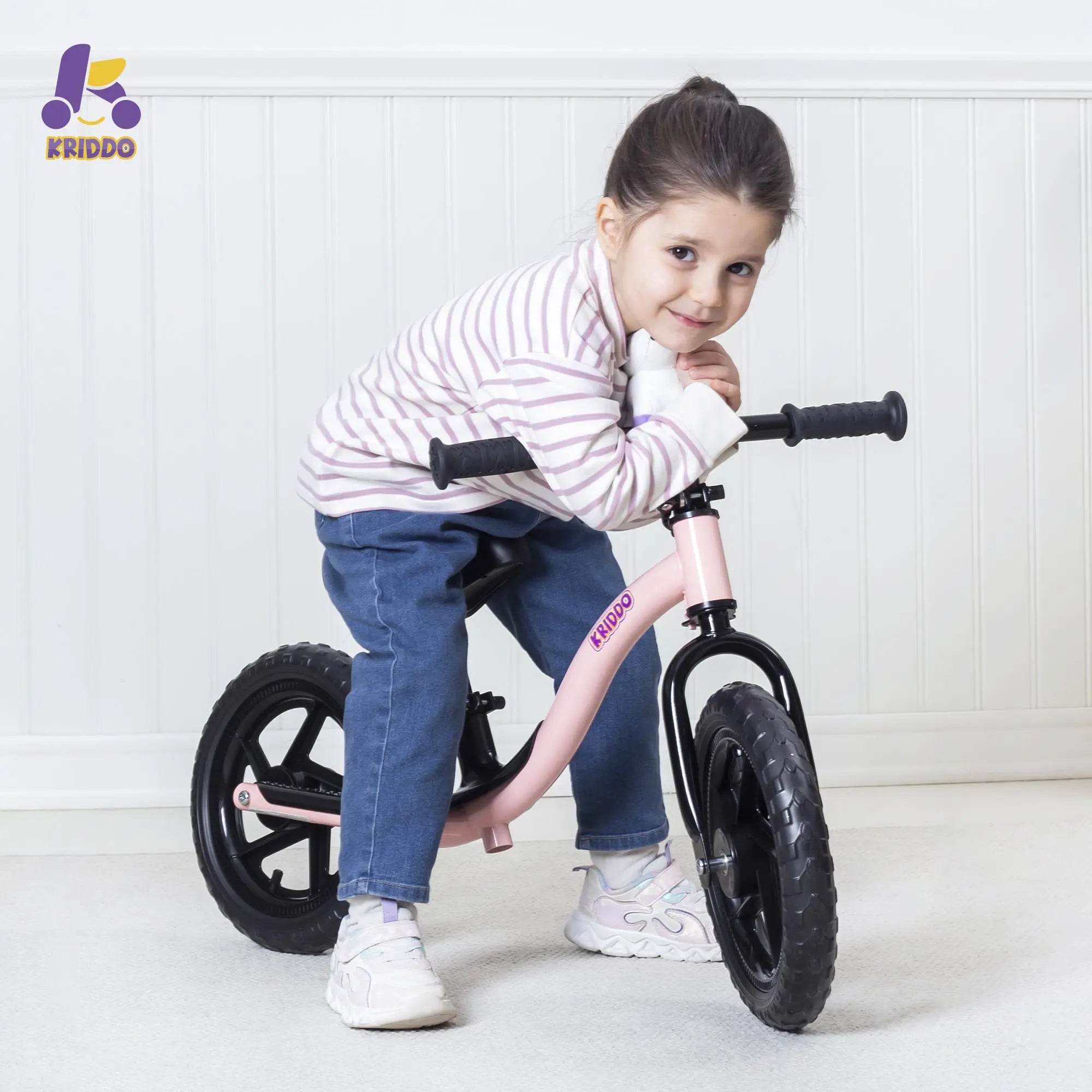 Little girl on KRIDDO pink toy balance bike
