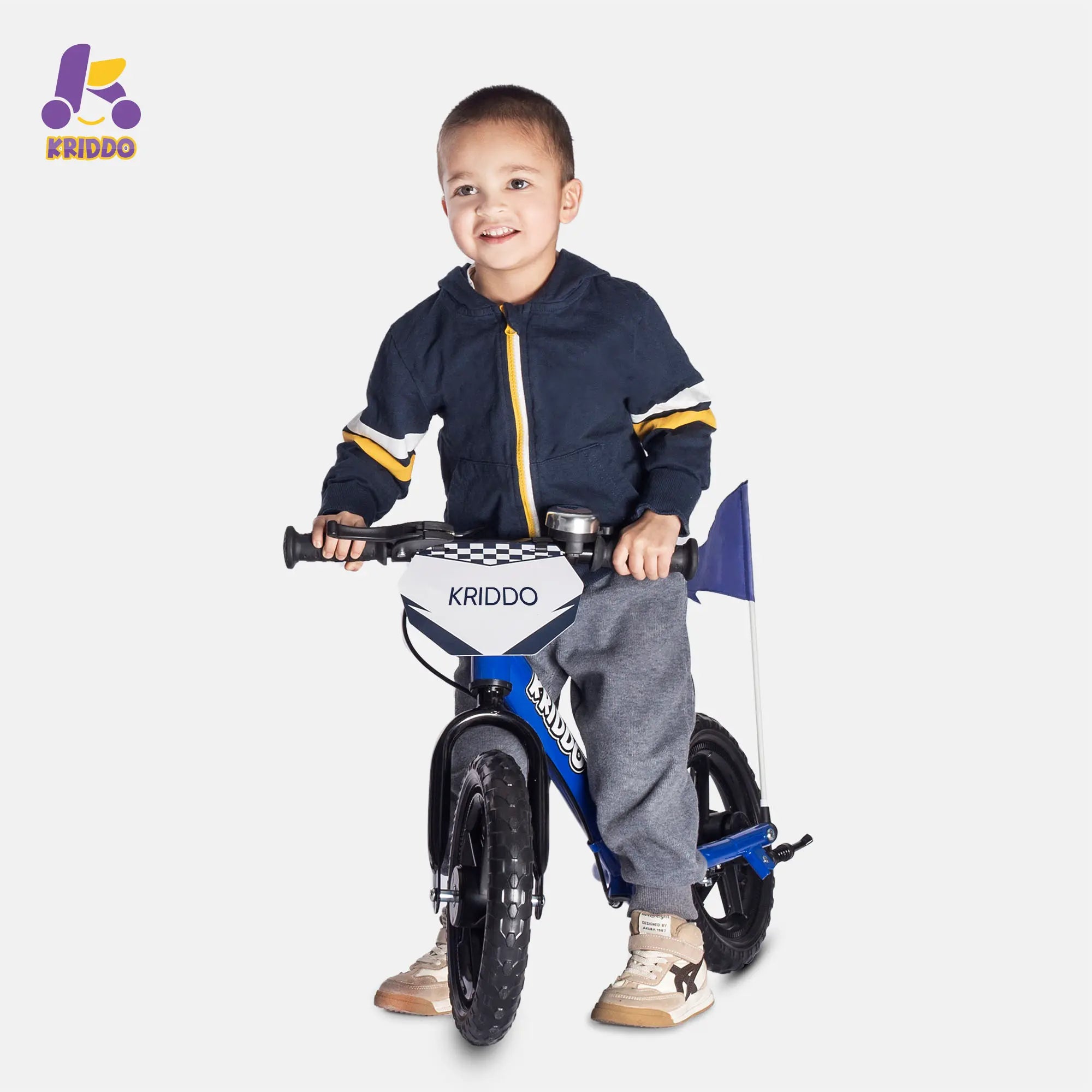 Child holding a balance bike with brakes and flag
