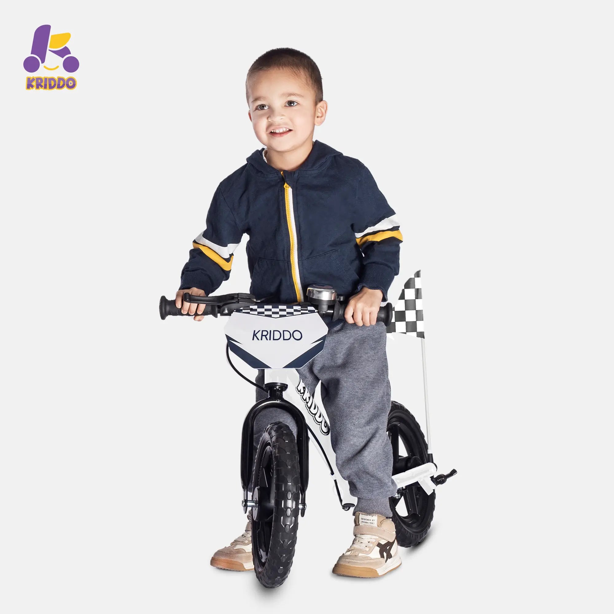 Child holding a balance bike with brakes and flag