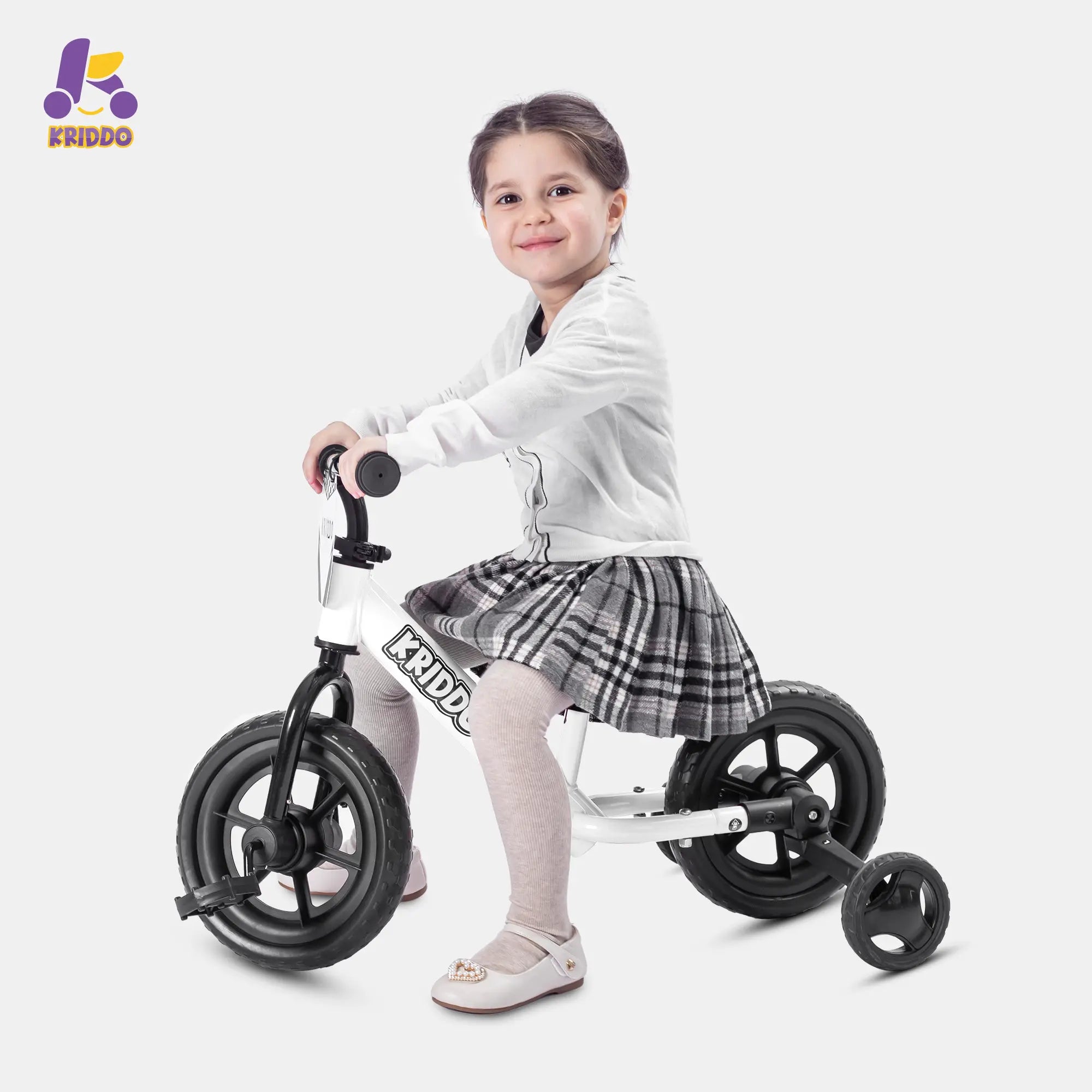 Child sitting on KRIDDO convertible balance bike with training wheels