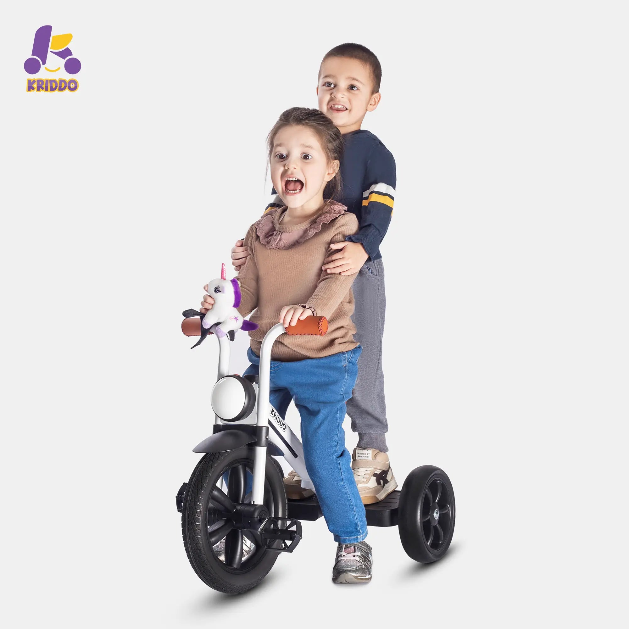 Two kids standing on KRIDDO white pedal tricycle with highlight
