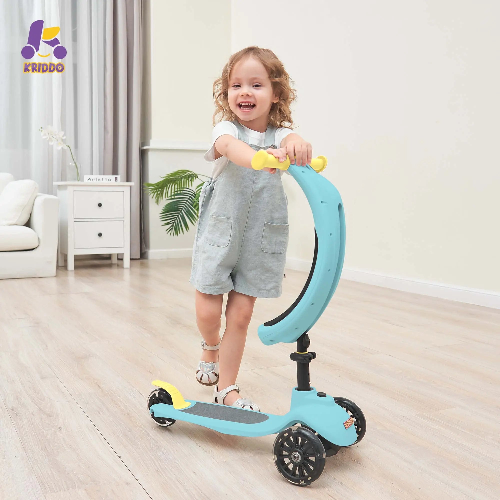 Little girl riding KRIDDO blue scooter in a room