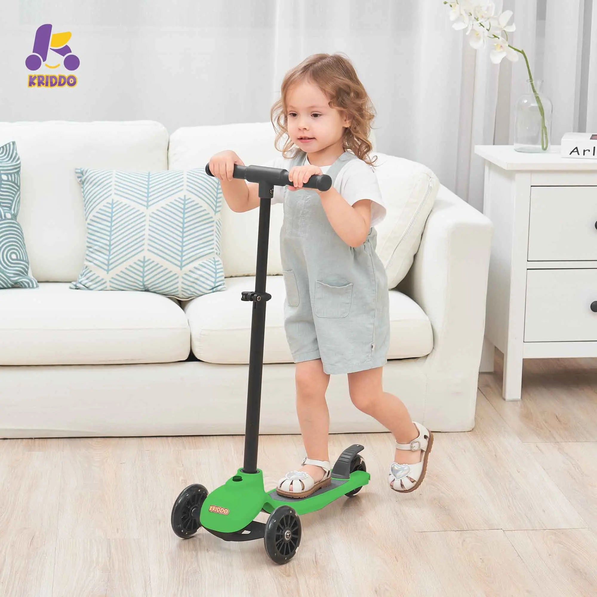 Toddler girl riding KRIDDO 5 in 1 scooter in a living room