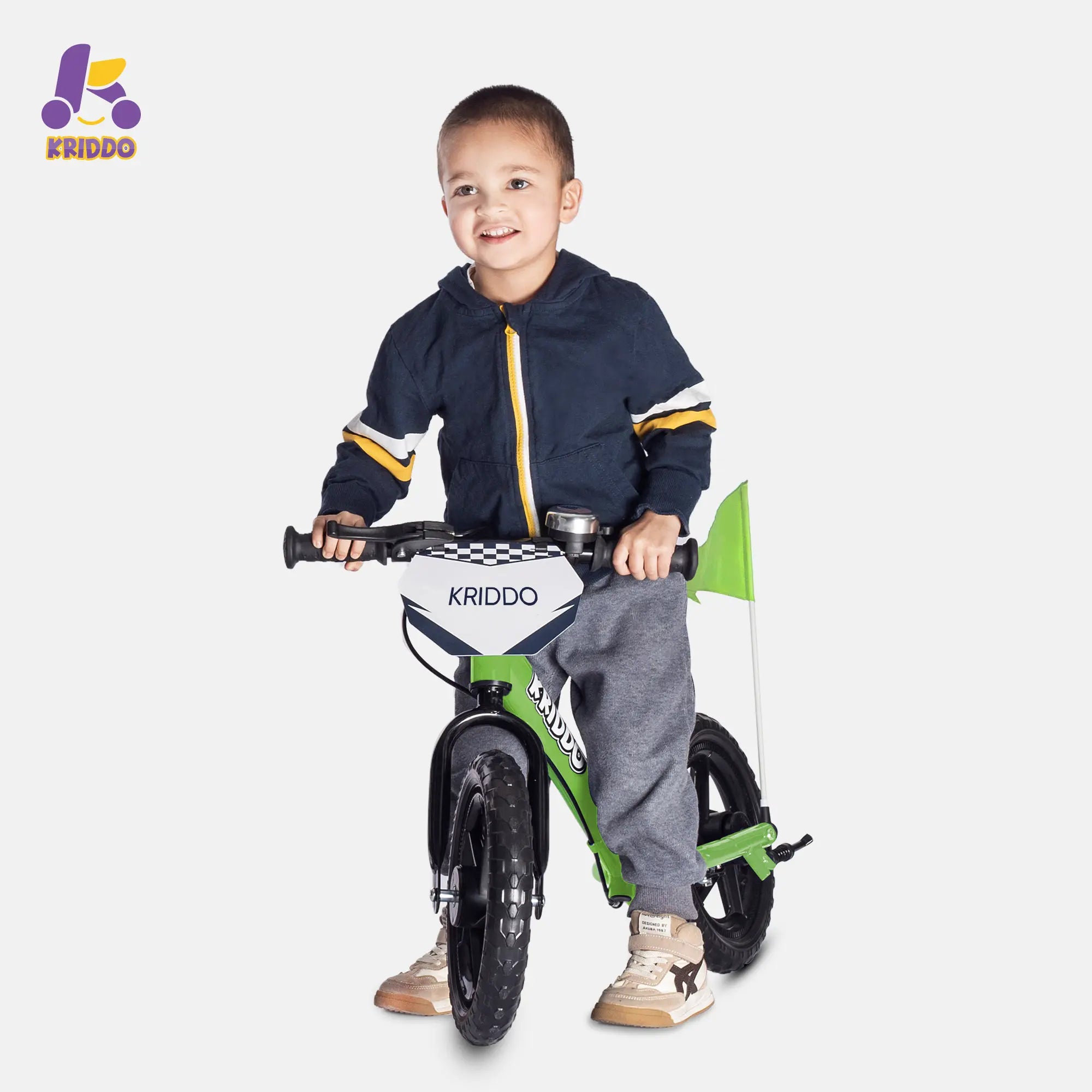 Little boy holding a balance bike with brakes and flag