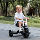 Child riding KRIDDO Buzz Rider tricycle in a park