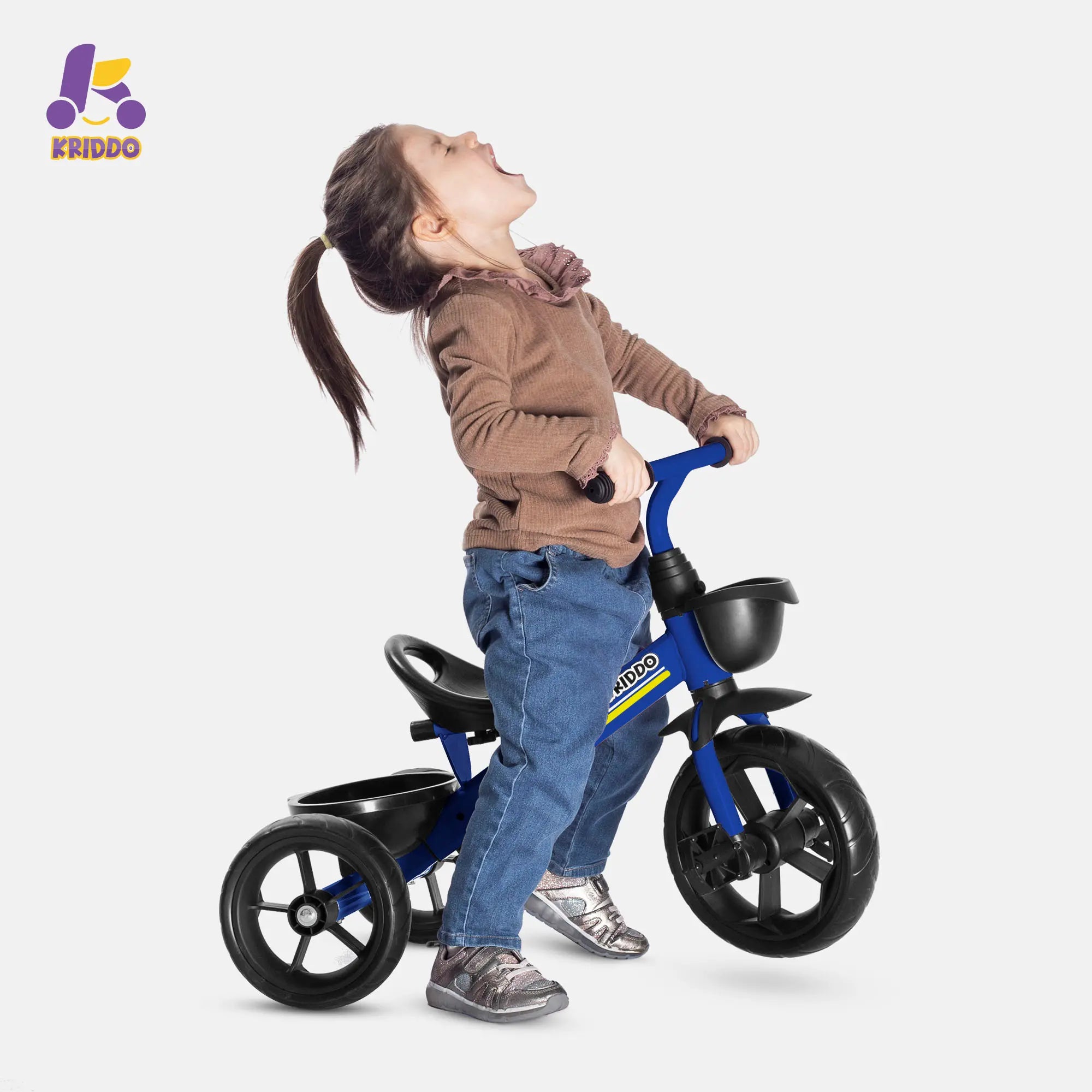 Child standing next to KRIDDO blue training tricycle on a white background, with 'Kriddo' logo.