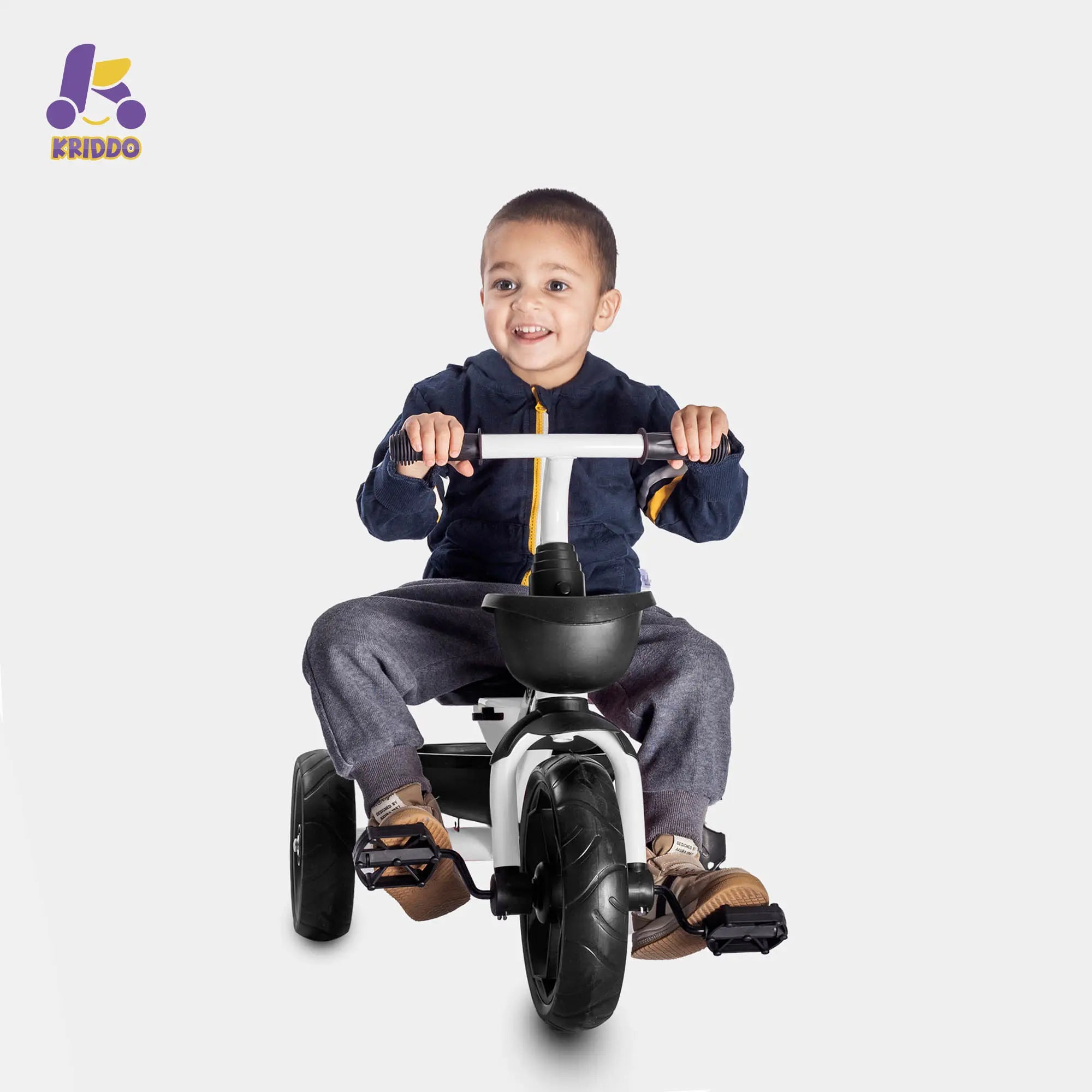 Boy riding a KRIDDO white 3 wheel bike happily 