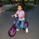 Toddler girl riding KRIDDO glowing balance bike in the park
