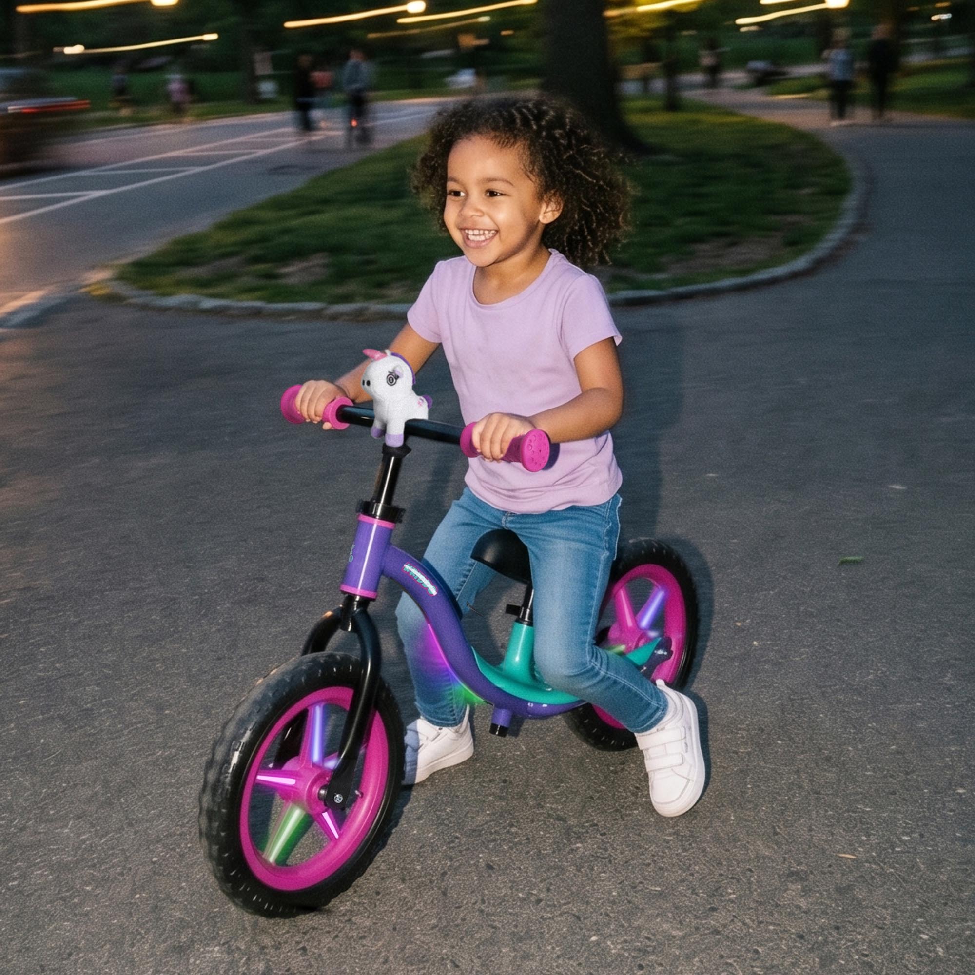 Toddler girl riding KRIDDO glowing balance bike in the park