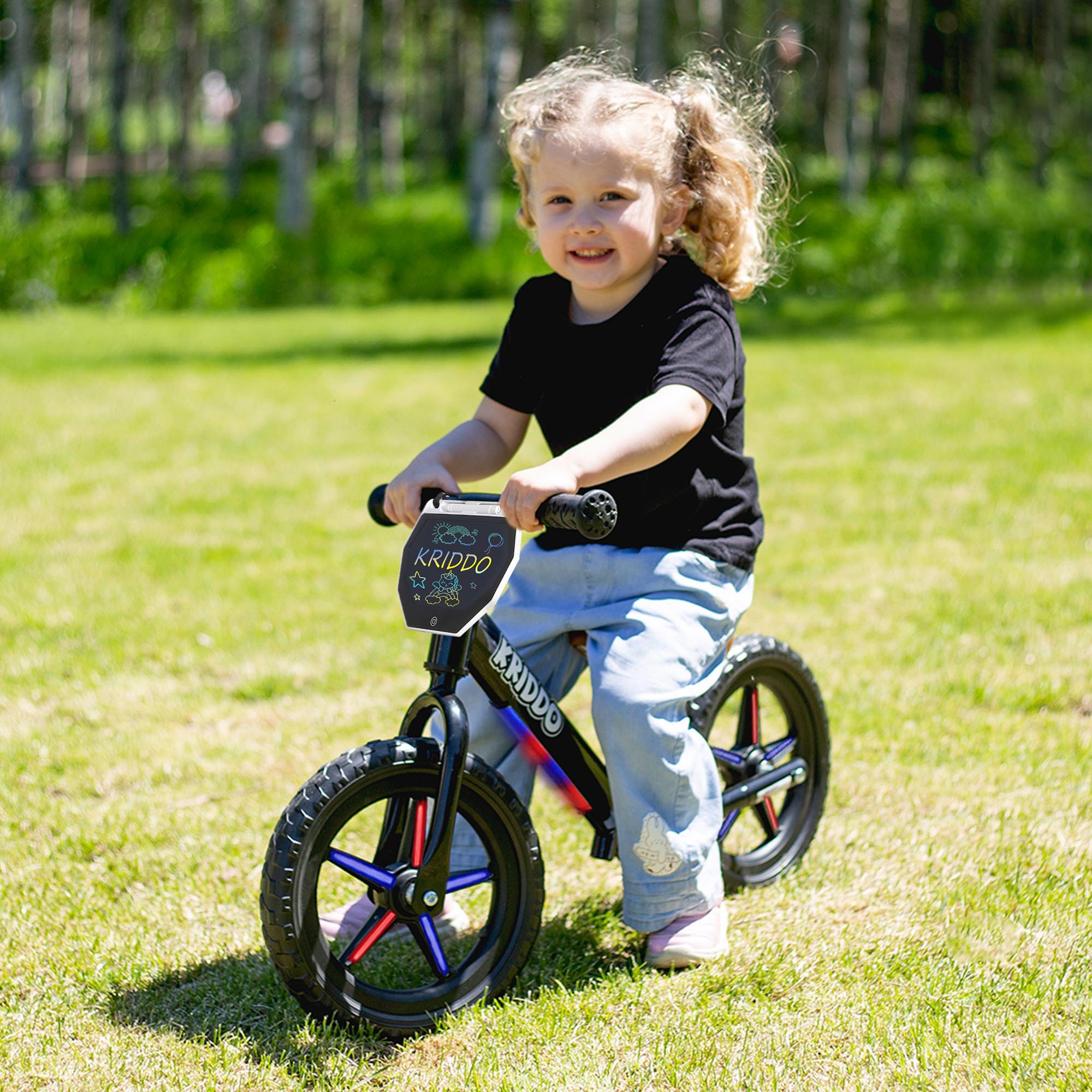 Child riding KRIDDO balance bike with light up wheels